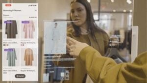 woman using digital mirror in store to make purchase